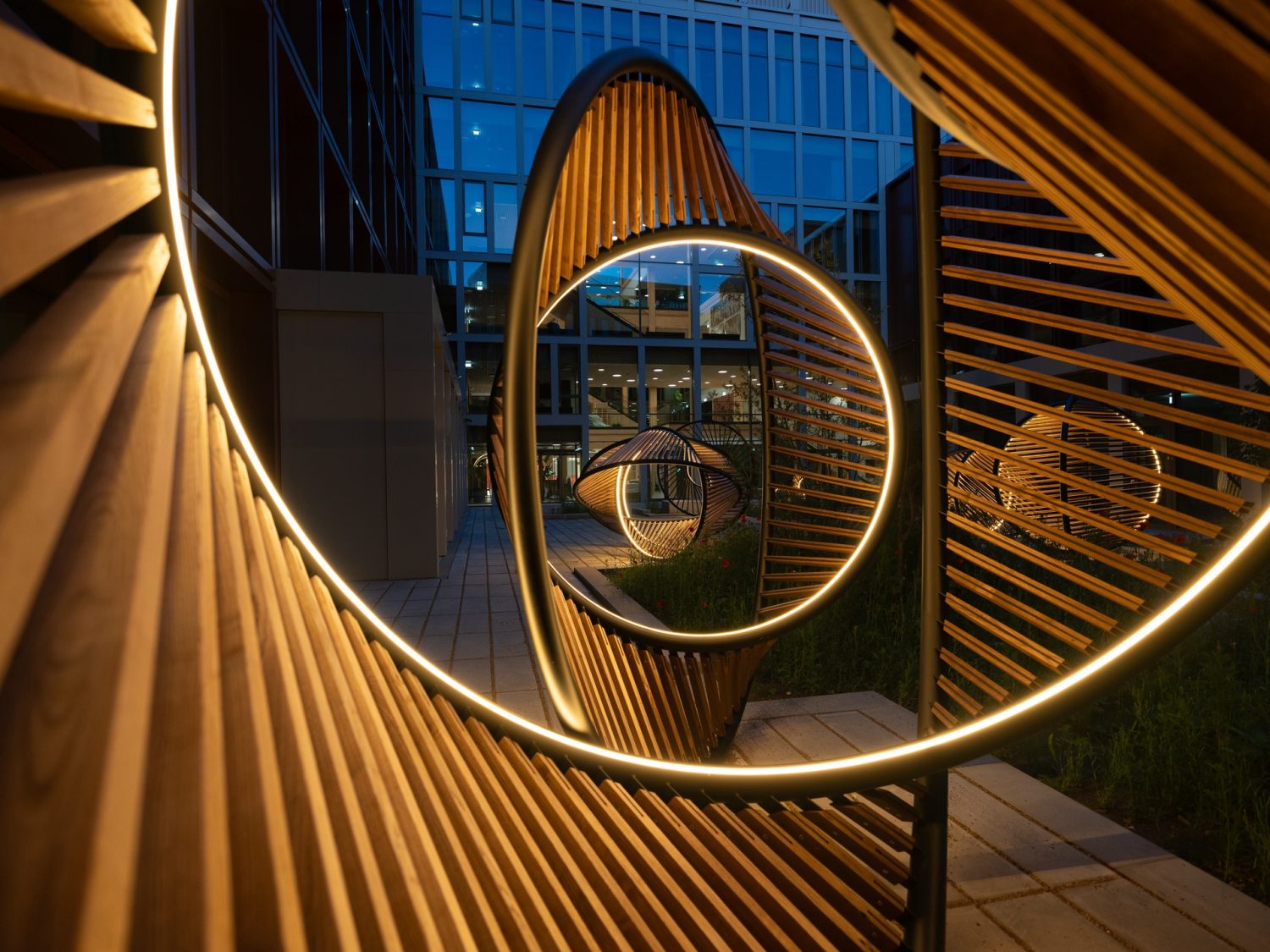 Night view looking through a series of sculptures